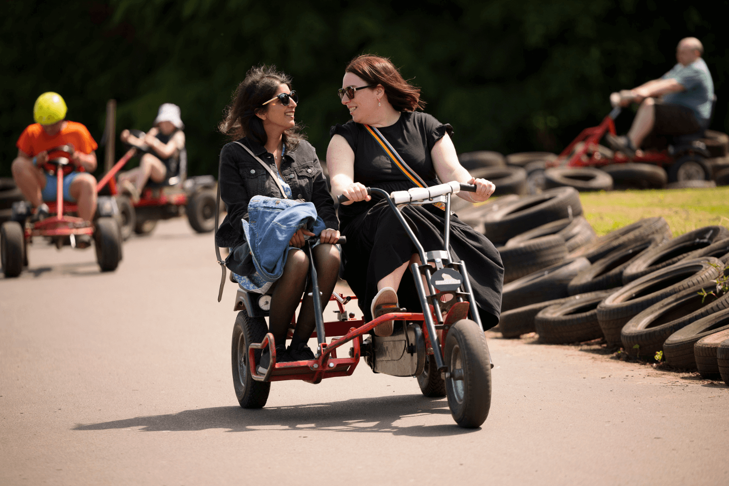 Two women enjoying pedal go karts at Stockeld Park