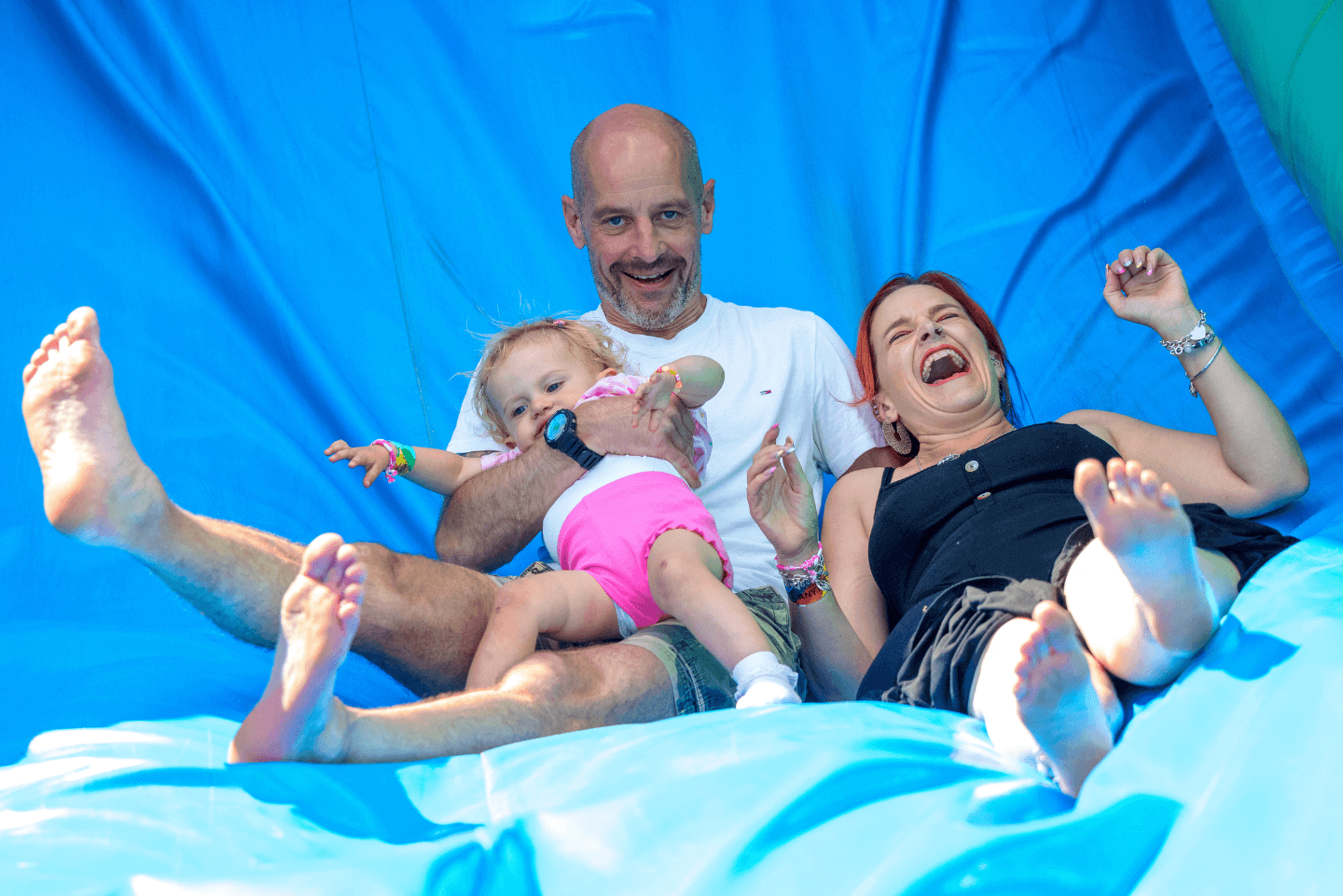 Family enjoying inflatable outdoor slide