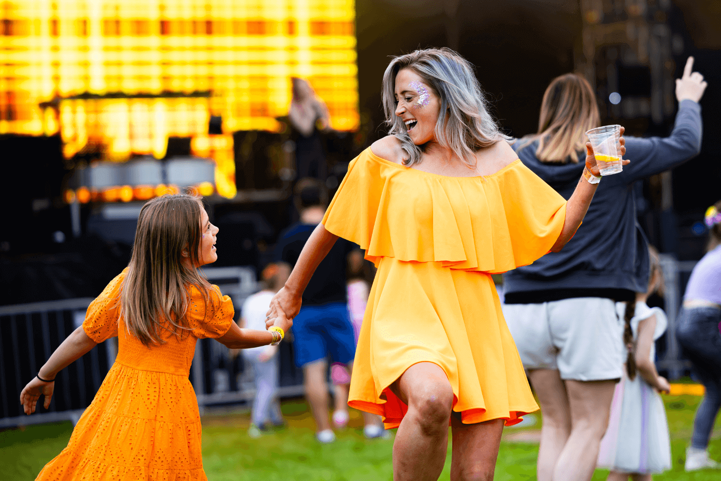 Woman dancing with child enjoying live music at Stockeld Park