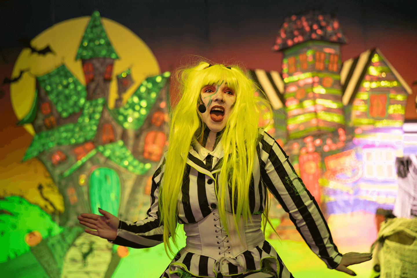 Woman dressed like beetlejuice performing in a kids show