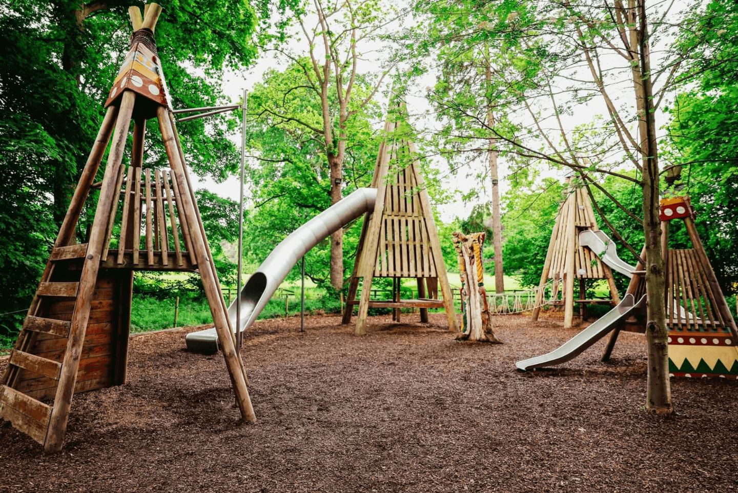 Outdoor adventure playground themed as a tepee encampment