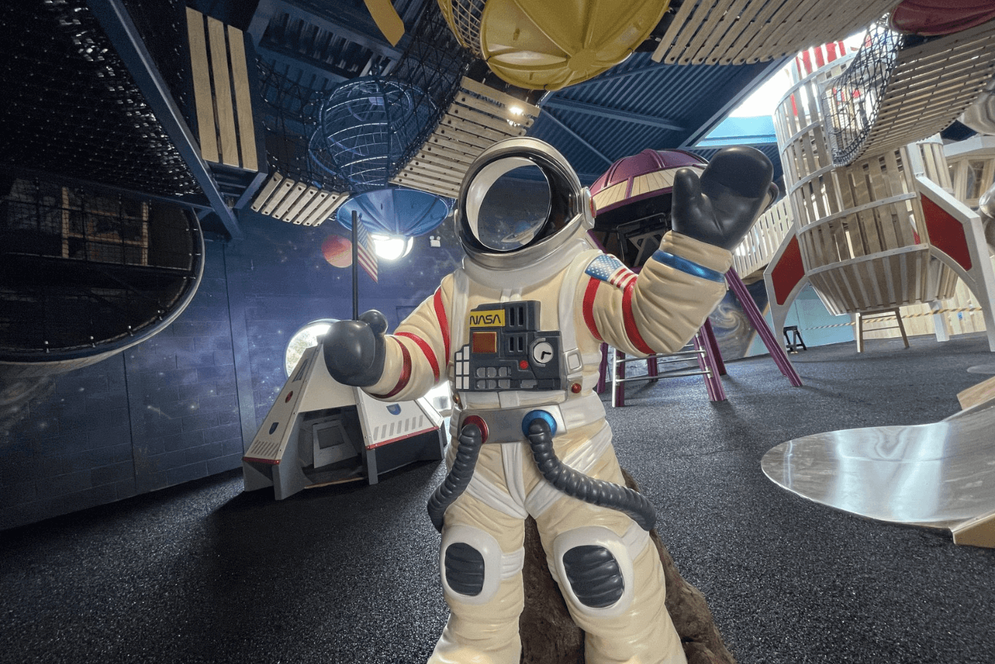 Astronaut figurine situated in a space-themed indoor play area