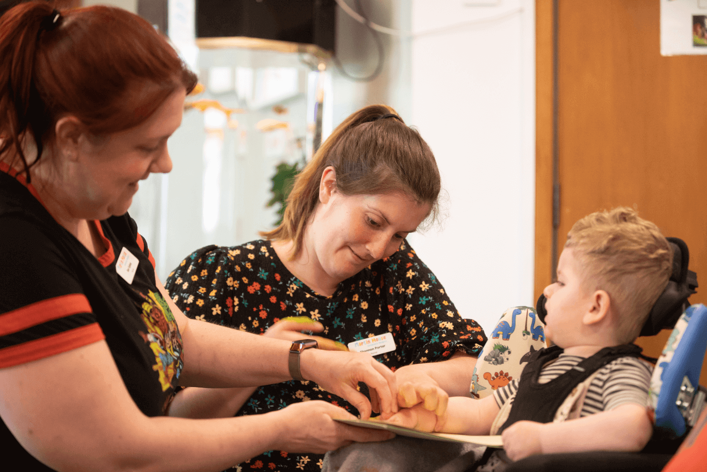 Two female carers looking after a child in Martin House